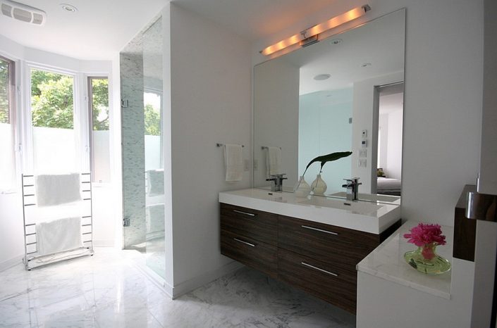 Floating wooden vanity in the bathroom mirror